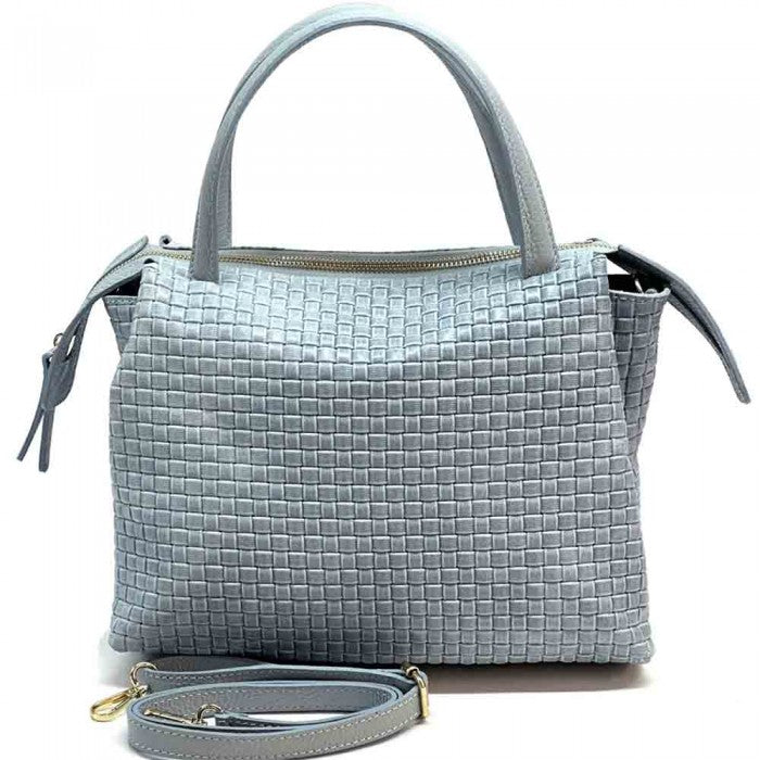 A cow leather handbag with a woven pattern, featuring dual handles and a shoulder strap.