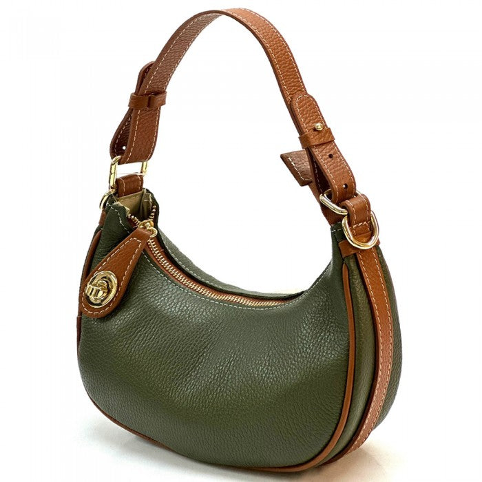 A Noemi leather handbag with a pebble-grain texture, featuring a crescent shape, vintage brass hardware, a detachable shoulder strap, and a top handle.