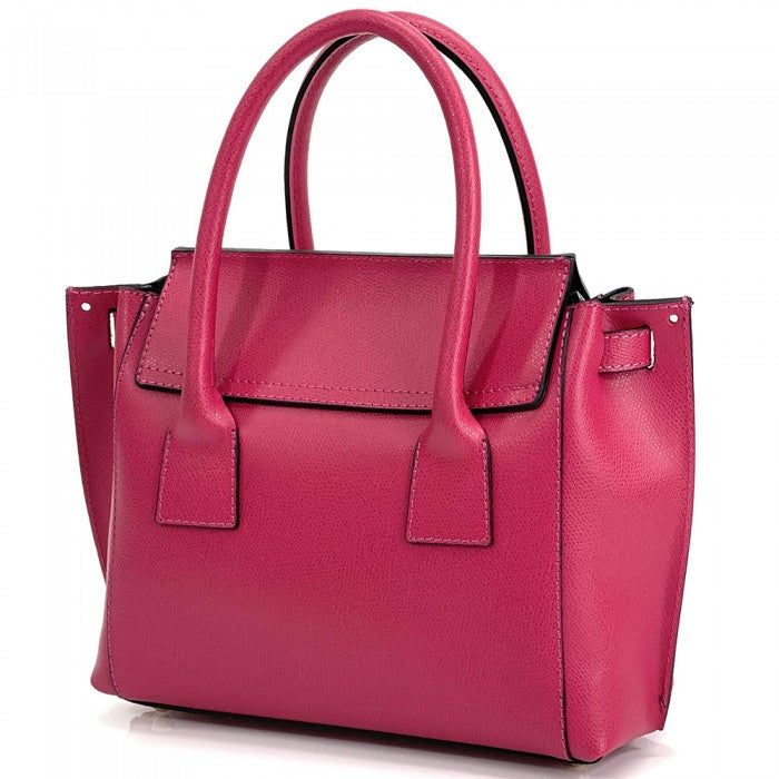 A pink Italian leather handbag with a structured design, double handles, and a gold-tone clasp.