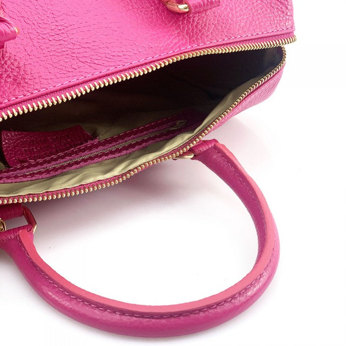 A pink Erminia GM cow leather handbag with visible texture, two handles, and metallic hardware.