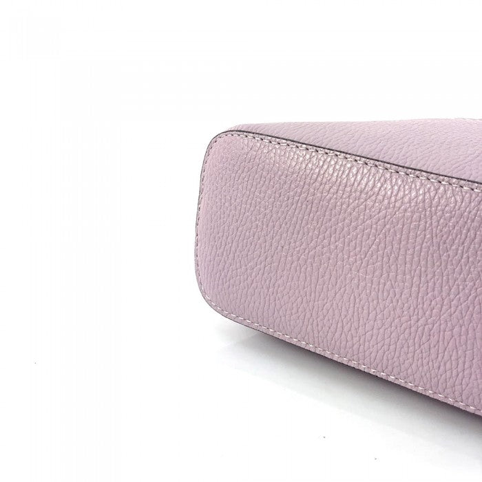 A pink Bellaria Italian leather shell bag, showcasing the gold-tone zipper and a double top handle.