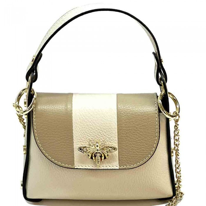 A black and white leather handbag with a gold bee metal embellishment, featuring a structured silhouette and a metal chain strap.