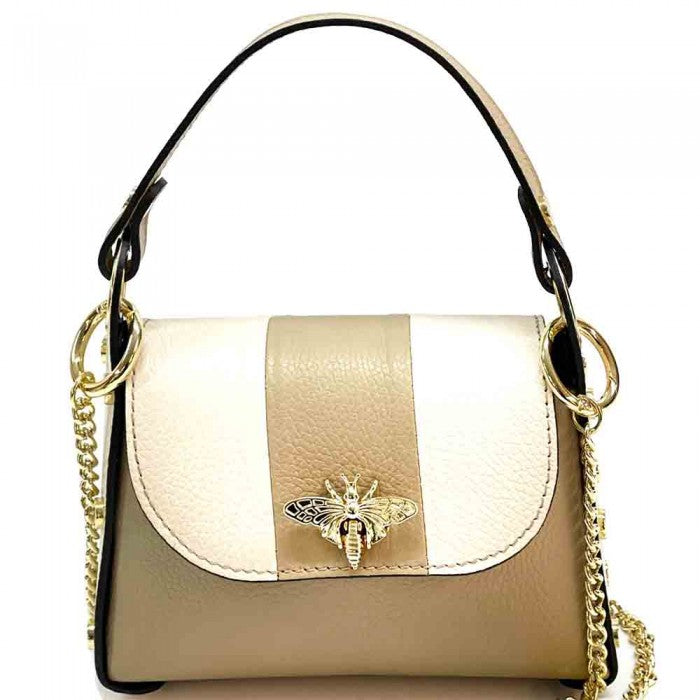 A black and white leather handbag with a gold bee metal embellishment, featuring a structured silhouette and a metal chain strap.