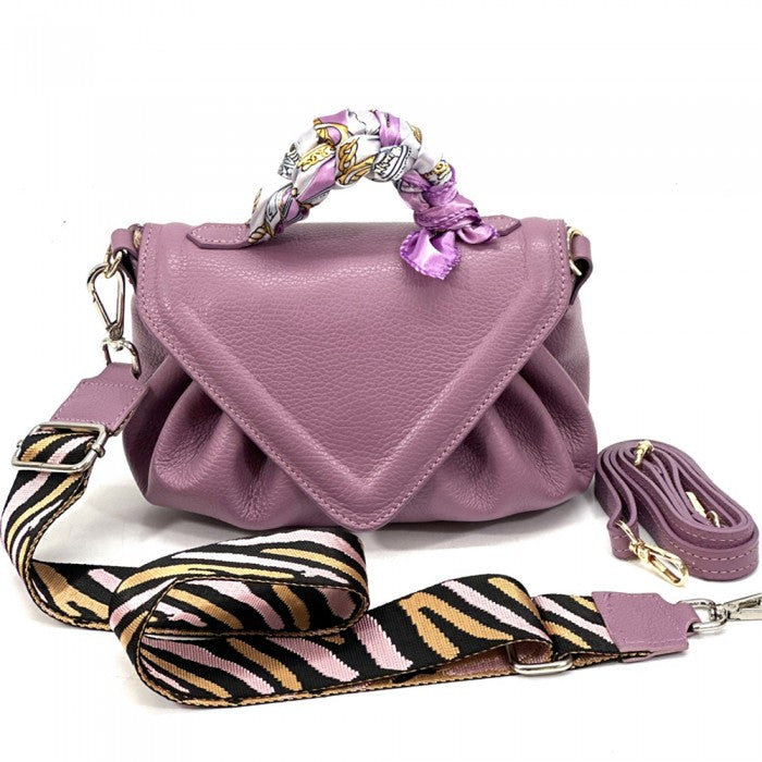A purple leather handbag with a unique patterned handle and a detachable zebra-patterned shoulder strap.