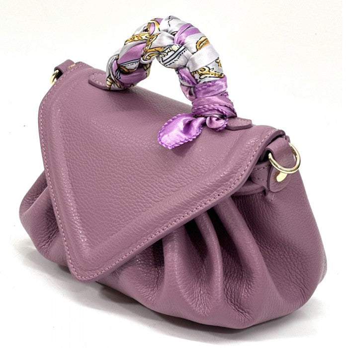 A purple leather handbag with a unique patterned handle and a detachable zebra-patterned shoulder strap.