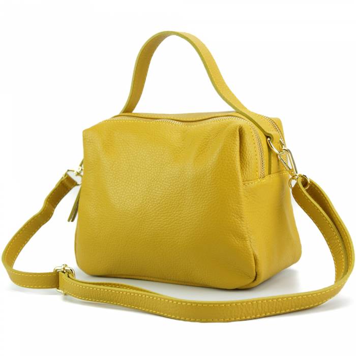 Yellow leather handbag with a zipper closure and metallic pieces, with both a shoulder strap and handle.