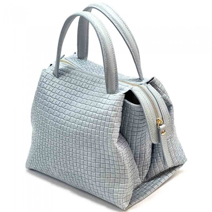 A cow leather handbag with a woven pattern, featuring dual handles and a shoulder strap.