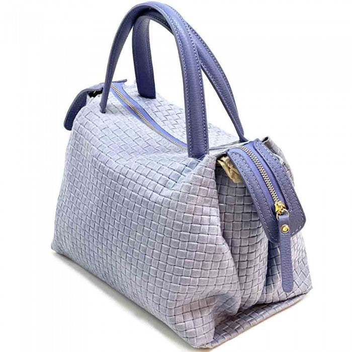 A cow leather handbag with a woven pattern, featuring dual handles and a shoulder strap.