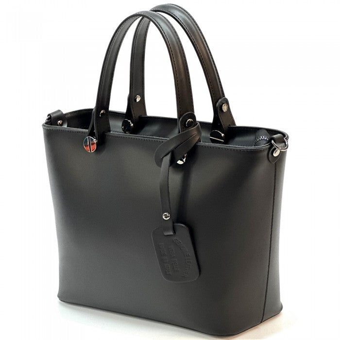 A  leather tote bag with two handles and a detachable shoulder strap.