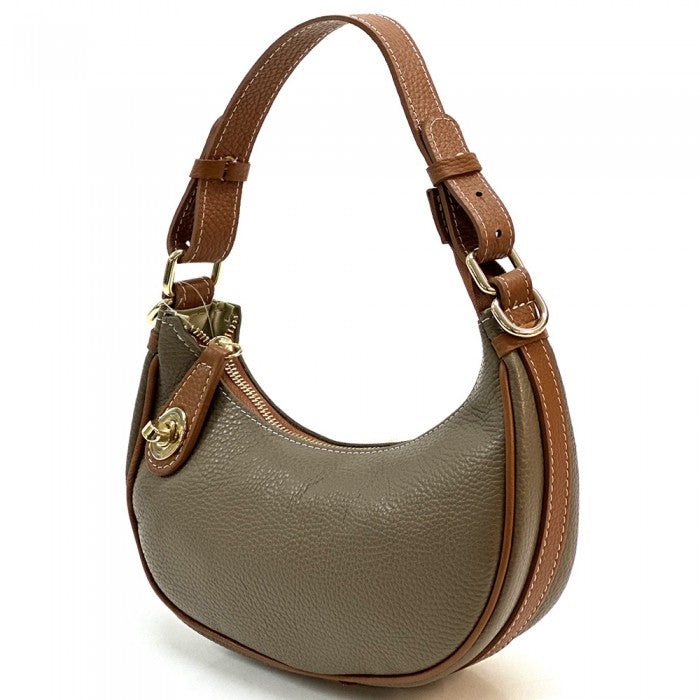 A Noemi leather handbag with a pebble-grain texture, featuring a crescent shape, vintage brass hardware, a detachable shoulder strap, and a top handle.