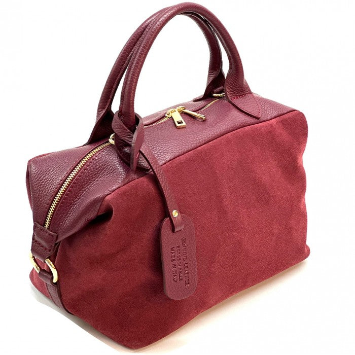 A Emma Leather Boston Bag with suede texture and black leather trimmings, featuring dual top handles and a detachable shoulder strap.