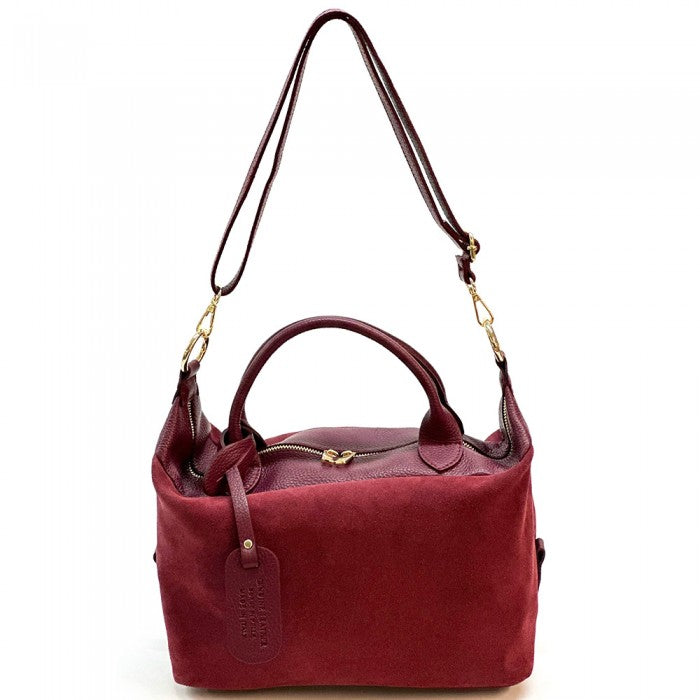 A Emma Leather Boston Bag with suede texture and black leather trimmings, featuring dual top handles and a detachable shoulder strap.