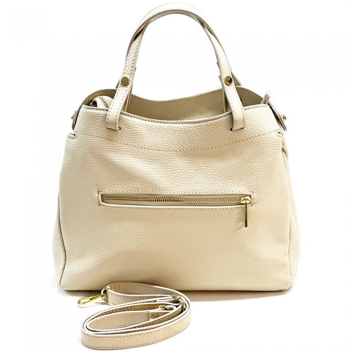 A beige Siena handbag made of premium Italian leather, featuring a structured silhouette with soft curves and gold-tone hardware, designed for both casual and formal settings.