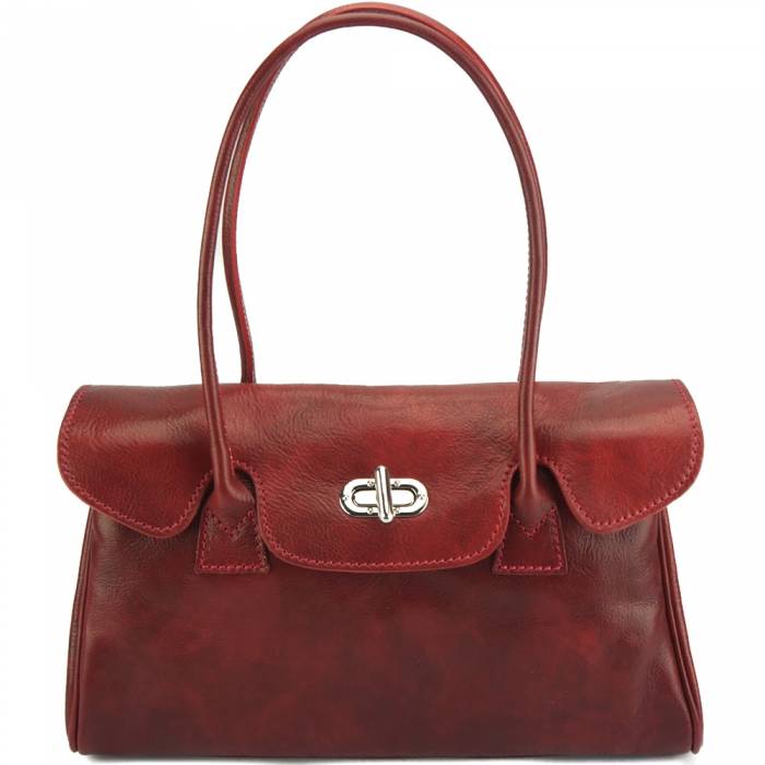 A red calf leather handbag with double handles and a front flap with a twist fastening clasp.