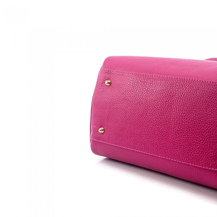 A pink Erminia GM cow leather handbag with visible texture, two handles, and metallic hardware.