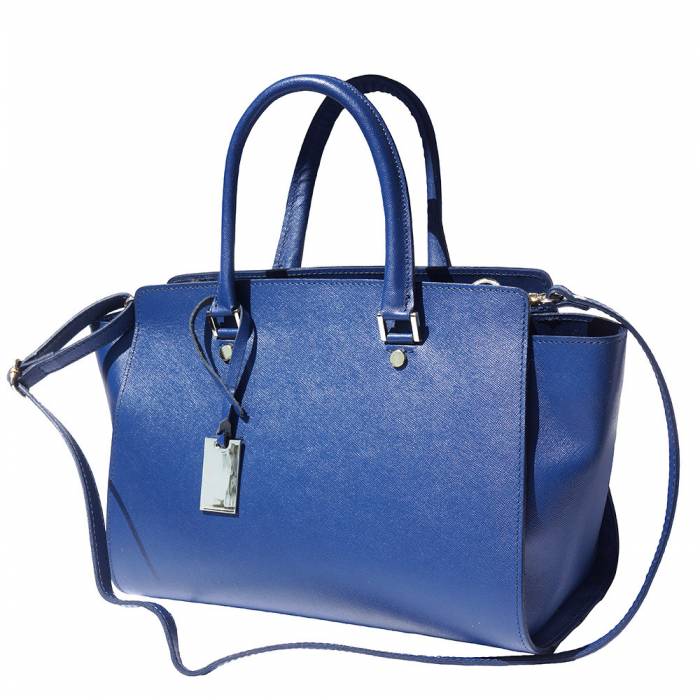A blue leather handbag with golden metal hardware and a decorative tag on one of the handles.
