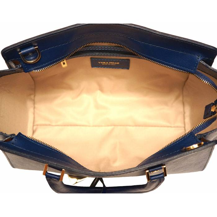 A blue leather handbag with golden metal hardware and a decorative tag on one of the handles.