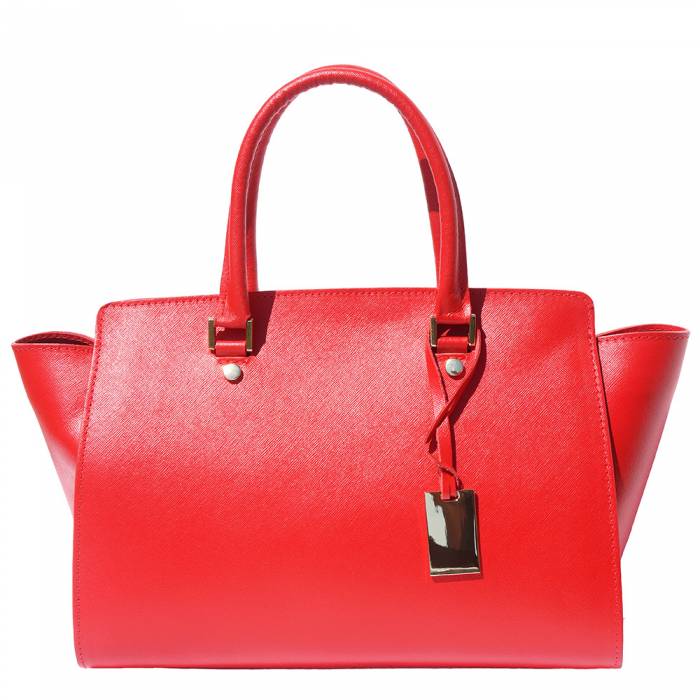 A red leather handbag with golden metal hardware and a decorative tag on one of the handles.
