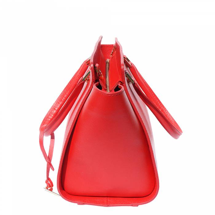 A red leather handbag with golden metal hardware and a decorative tag on one of the handles.