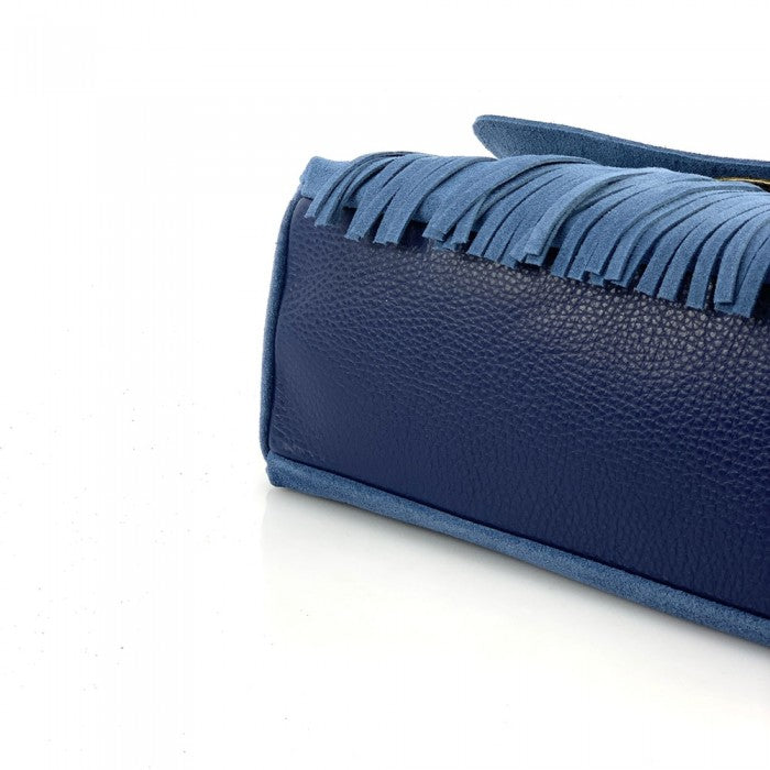 A purple leather handbag with a unique patterned handle and a detachable zebra-patterned shoulder strap.