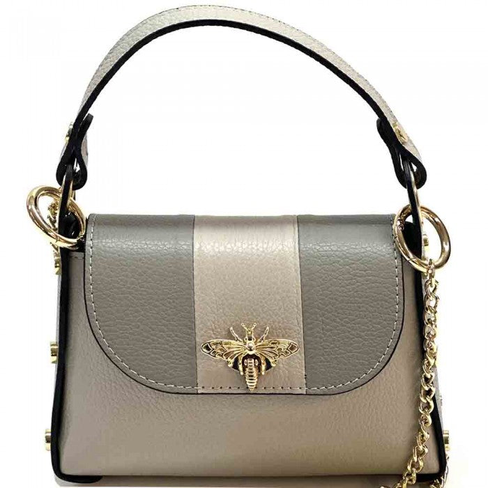 A black and white leather handbag with a gold bee metal embellishment, featuring a structured silhouette and a metal chain strap.