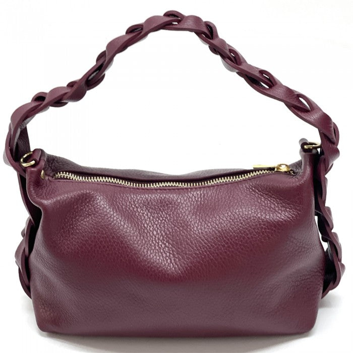 A blue crescent-shaped leather handbag with a single handle and a zipper closure.