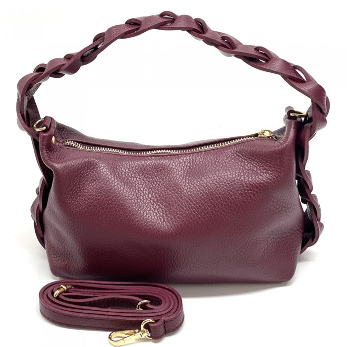A blue crescent-shaped leather handbag with a single handle and a zipper closure.