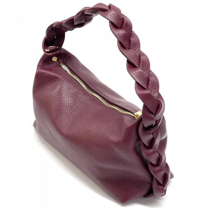 A blue crescent-shaped leather handbag with a single handle and a zipper closure.