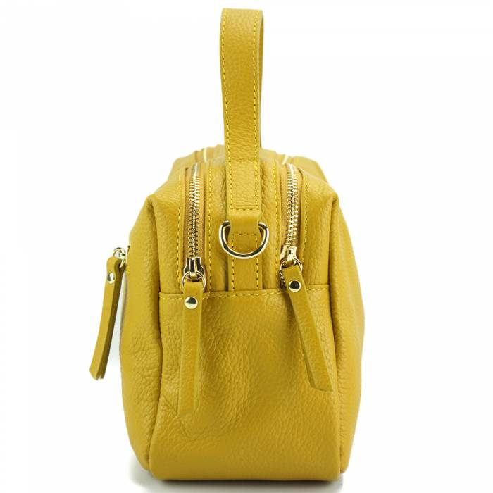 Yellow leather handbag with a zipper closure and metallic pieces, with both a shoulder strap and handle.